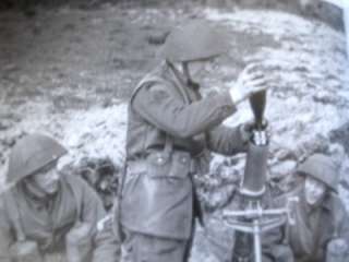 CHECK OUT PHOTO #5 OF A WW2 MORTAR TEAM. LOADER IS WEARING THE KHAKI 