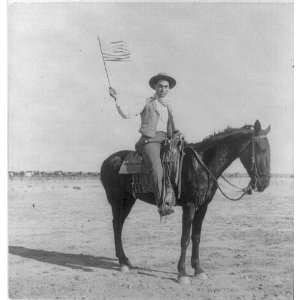  Cowboy on horseback waving US flag,c1901