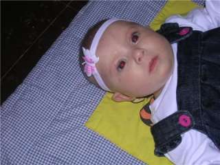 Below Baby Isabelle aged 16 weeks wearing her pink and white butterfly 