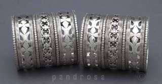 pair of nice silver bracelets with open work floral design.